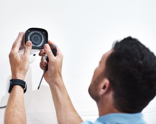 can-you-guys-see-me-down-there-shot-mature-man-installing-security-camera-building_590464-22169