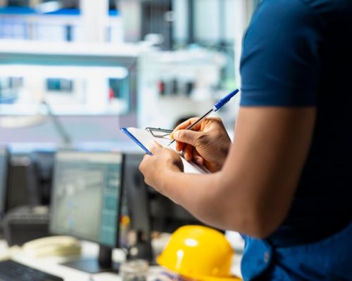 solar-panel-manufacturing-plant-researcher-taking-notes-files_482257-125791